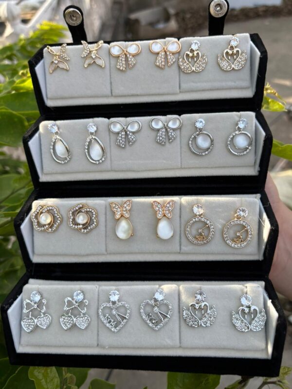 Trendy Korean style earrings and American Diamond studs collection displayed in a black velvet jewelry box.