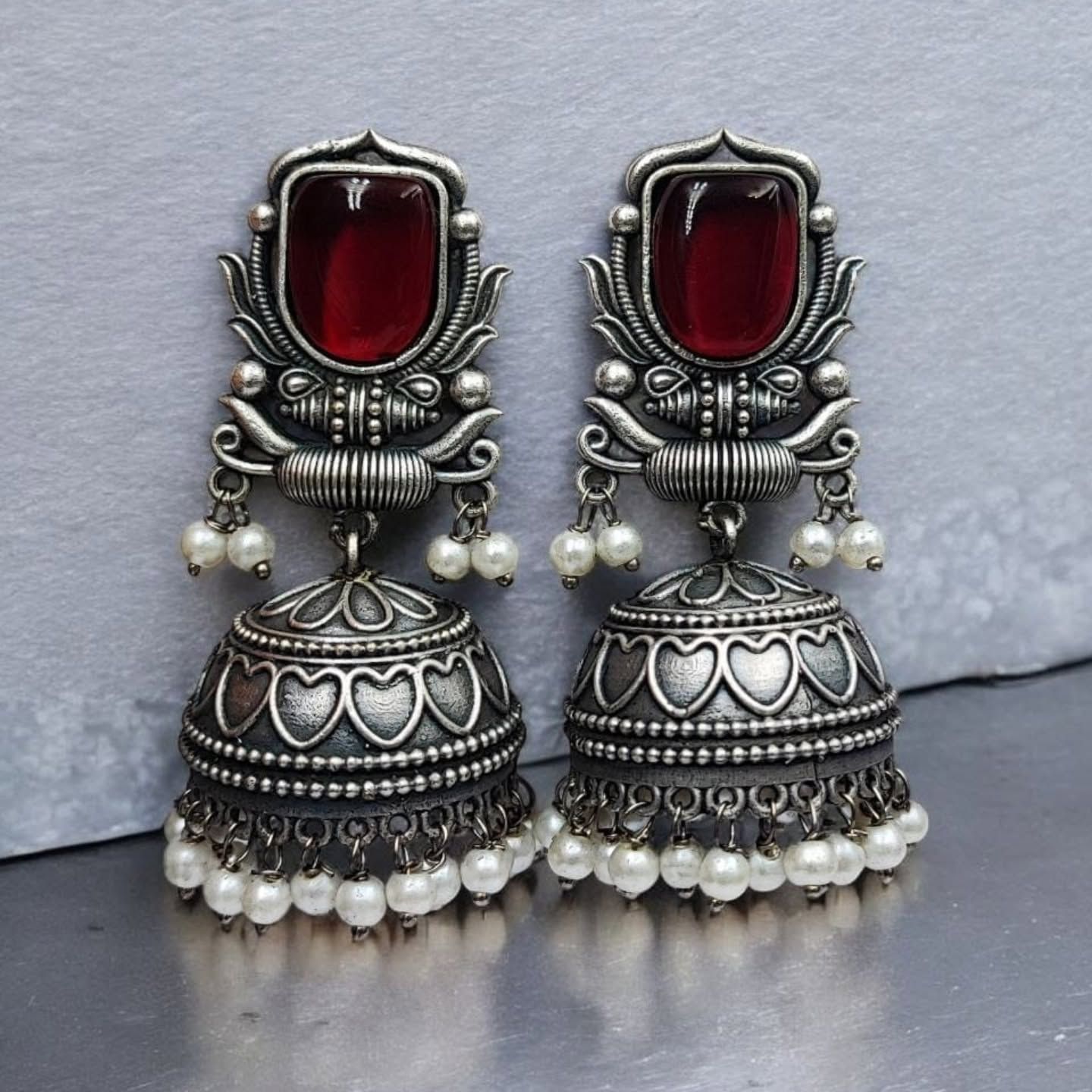 Oxidised silver artificial jhumka earrings with red stone and pearl drops